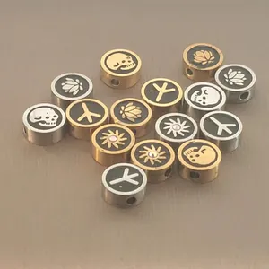Detail showing enameled skull and lotus patterns on stainless steel beads for DIY jewelry.