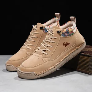 Detailed side view of tan suede mid-top Martin boots with colorful ethnic pattern