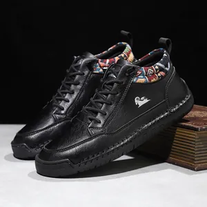 Detail view of black leather mid-top boots with colorful patterned collar and logo.