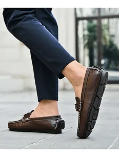 Gros plan de mocassins en cuir marron avec surpiqûres blanches et semelle en caoutchouc