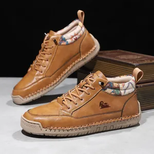 Detailed view of brown mid-top casual boots with ethnic collar and ram logo