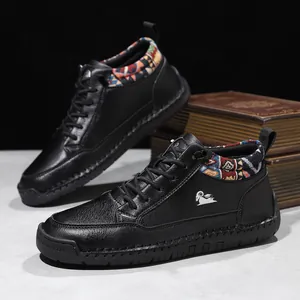 Detail of black mid-cut Martin boots with colorful patterned collar and goat logo.