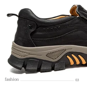 Macro detail shot showing the stitching and thick rubber sole of black leather shoes.