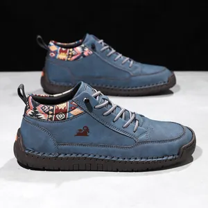 Detail of blue mid-top Martin boots with ethnic patterned collar and stitched sole.