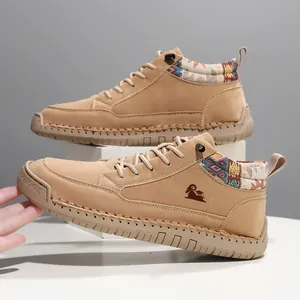 Detail view of khaki mid-top casual boots with ethnic patterned collar and hand stitching