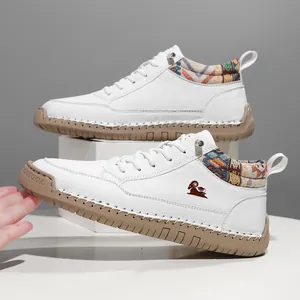 Detailed view of white mid-top casual Martin boots featuring ethnic patterned ankle collar