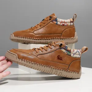 Detail view of brown leather outdoor boots with patterned ankle collar and hand-stitched sole