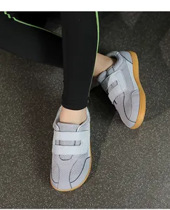 Top view of grey breathable fly-knit sneakers with double hook-and-loop straps