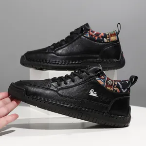 Detailed side view of black leather casual boots with ethnic pattern collar detail