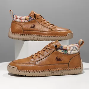 Detailed view of brown mid-top Martin boots with ethnic patterned collar and stitched sole.