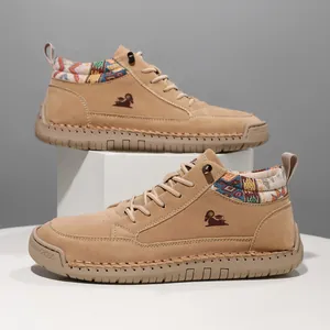 Tan suede mid-top Martin boots with ethnic patterned collar and stitched rubber sole