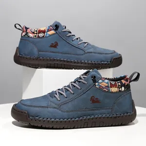 Detailed view of blue mid-top outdoor Martin boots with ethnic patterned ankle trim