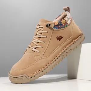 Detailed view of camel mid-top Martin boots with ethnic pattern and rubber sole