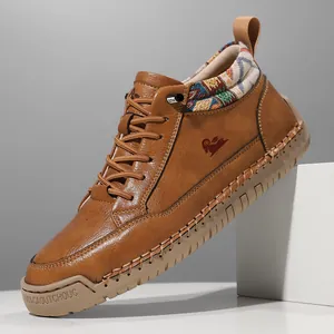 Detail view of brown leather mid-top casual boot featuring a patterned textile ankle collar