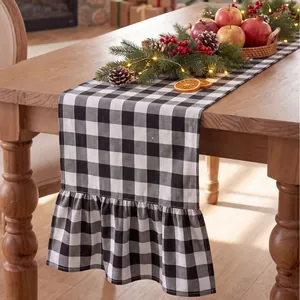 Detailed view of black and white buffalo plaid table runner with elegant ruffled edges