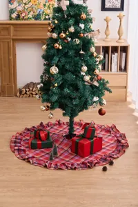 Detail of red plaid Christmas tree skirt with ruffled edges in a cozy room