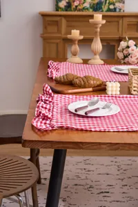 Red and white checkered hand towel with elegant ruffled edges in lifestyle setting