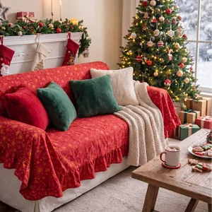 Red Christmas ruffled sofa cover with gold stamped festive patterns in a cozy room