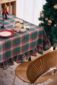 Detail view of the Christmas plaid tablecloth with elegant ruffle edges and festive pattern