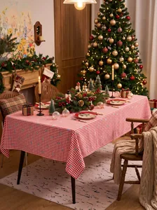 Red and white checkered Christmas tablecloth in a warm holiday dining room setting.