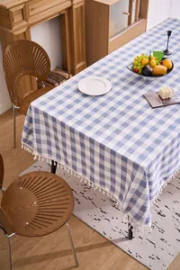 Blue and white checkered cotton linen tablecloth with decorative white tassels.