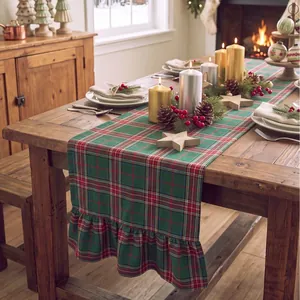 Detail showing the woven texture and ruffled edge of a Christmas plaid table runner