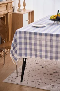 Blue and white checkered linen tablecloth with delicate white tassel fringe detail