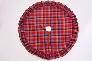 Detailed top view of a classic red and black plaid Christmas tree skirt with ruffles