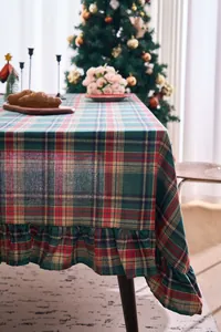 Red and green Christmas plaid tablecloth with ruffled edges in a festive scene