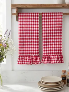 Detail of red and white gingham checkered hand towels with ruffled edges in kitchen