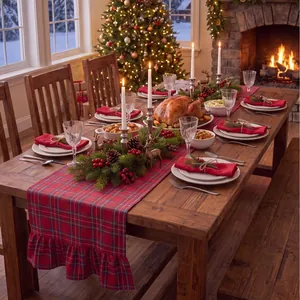 Close-up of red and green plaid table runner with ruffled edges in a festive Christmas setting