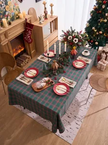 Detailed view of a festive green and red plaid tablecloth in a cozy Christmas dining room