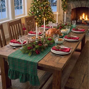Green plaid table runner with ruffled edges displayed in a Christmas dinner setting