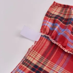 Red and white plaid Christmas tree skirt detail with ruffles and white elastic loop