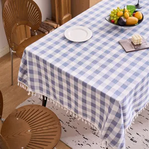 Elegant blue and white checkered cotton linen tablecloth with decorative tassel edges.