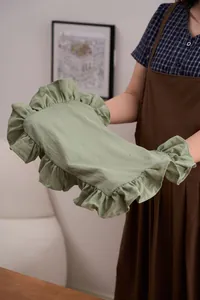 Detail van een saliegroene katoenen linnen placemat met elegante ruches langs de randen