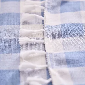 Elegant blue and white checkered cotton linen tablecloth featuring decorative white tassels
