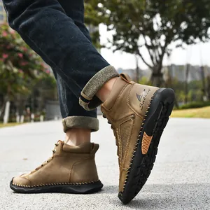 Close-up of brown PU leather men's ankle boots with handmade stitching and side logo detail