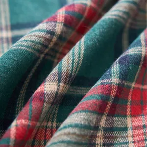 Close-up of green and red Christmas plaid tablecloth fabric with soft texture.