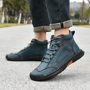 Close-up of blue PU leather men's ankle boots featuring orange handmade stitching