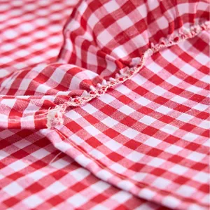 Red and white gingham hand towel featuring a decorative ruffled edge and soft texture