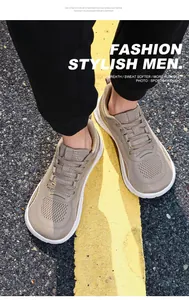 Detailed view of breathable khaki mesh men's walking shoes on an outdoor asphalt road