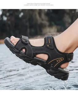 Close-up of men's black leather outdoor sandals featuring water-resistant design and orange accents.