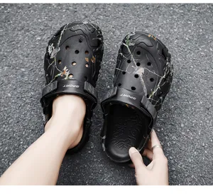 Detailed view of men's black camouflage clogs featuring breathable holes and thick soles
