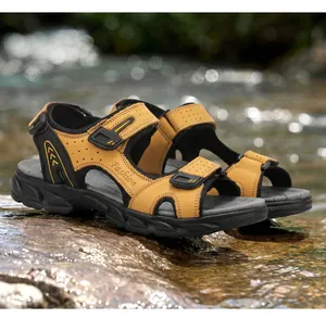 Detail of men's leather outdoor sandals on wet rocks near a stream