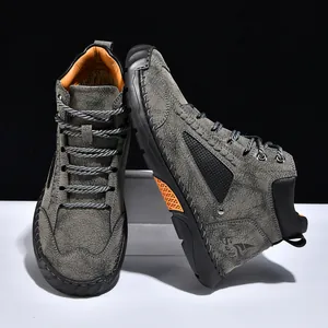 Close-up of grey textured PU leather ankle boots featuring hand-stitched craftsmanship