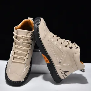 Detail view of handmade stitched beige PU leather ankle boots for men with rubber sole