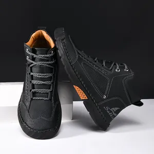Macro view of the fine hand-stitched details on these black men's PU leather ankle boots.