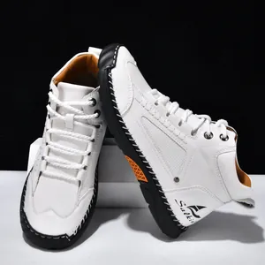 Detail of white PU leather ankle boot with black hand-stitched sole and lace-up design.