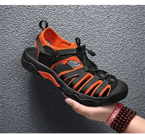 Side detail of orange and black outdoor sports sandals with elastic drawstring closure